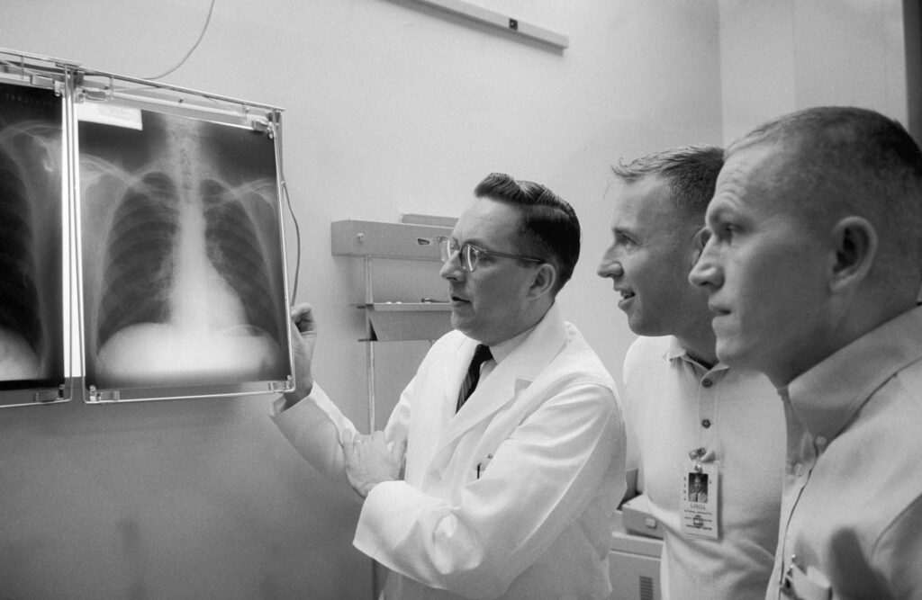 astronauts looking at x-rays from pre-flight checkups